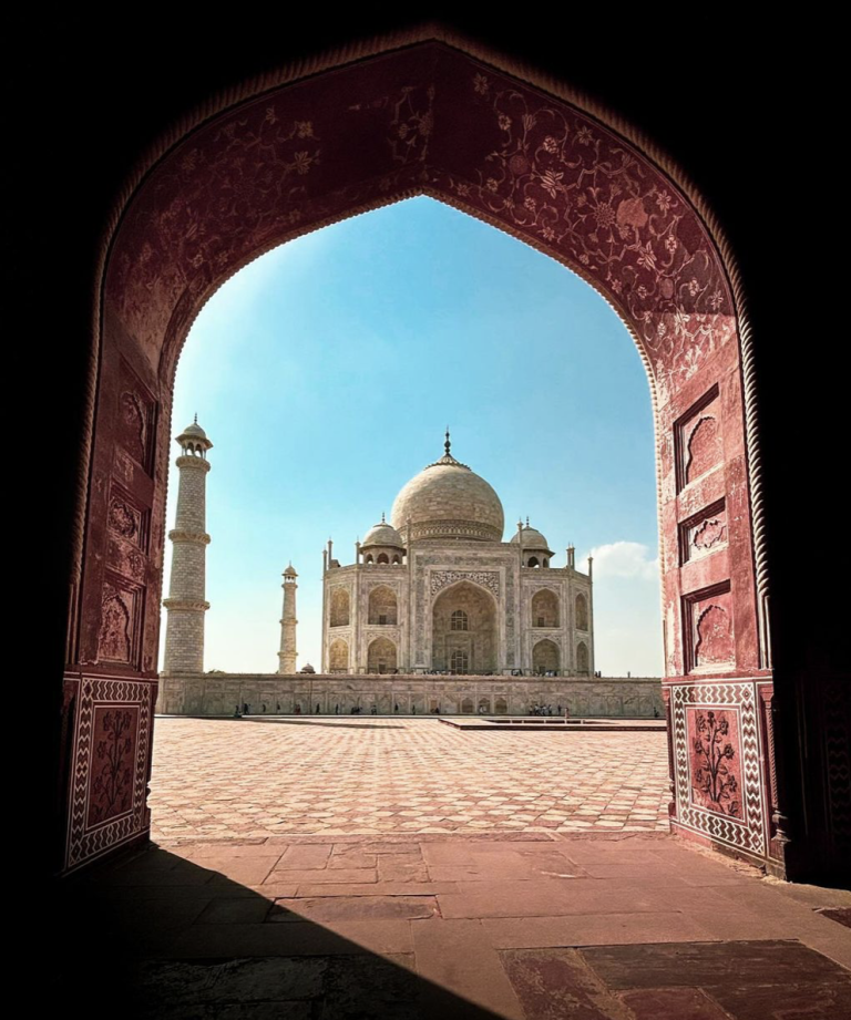 A breathtaking view of the Taj Mahal captured perfectly through an elegant archway.